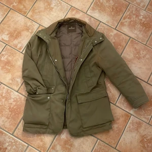 Field jacket från Moncler - Säljer en olivgrön field jacket från Moncler med lång ärm och flera praktiska fickor framtill. Jackan är strl 3 vilket motsvarar M/L. En av knapparna är trasiga men inget som inte går att laga. Skriv privat för fler blider eller funderingar😇