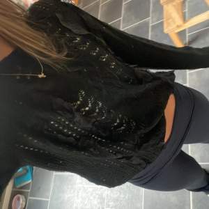 Snygg svart tröja med spetsdetaljer och långärmad design. Perfekt för en stilren look med en touch av elegans. Passar bra till både jeans och kjol. Storlek L men skulle säga s