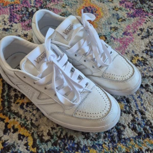 Vans – Lowland – Vita sneakers  - Fräscha helvita Vans sneakers med klassisk låg profil och rund tå. Använda ett fåtal gånger, lite skav på framsida samt fläckar på insidan.