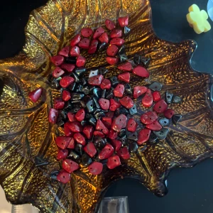 Mixade pärlor i olika färger och former - Säljer ett paket med mixade pärlor i rött, svart, turkost och brunt. Pärlorna har oregelbunden form och hål för smyckestillverkning, perfekta för att skapa egna armband, halsband eller örhängen.