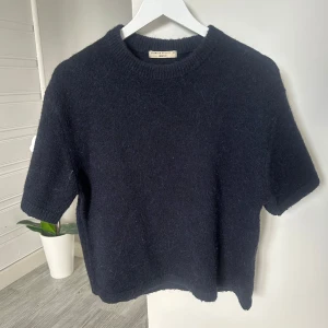 Stickad tröja - Kortärmad, mörkblå stickad tröja från Gina Tricot i storlek XS. Använd fåtal gånger.