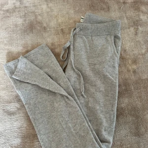 Grå kashmirbyxor - Supermjuka grå mjukisbyxor från Soft Goat med bred resår och snörning i midjan. Byxorna har raka ben och sidofickor🩷