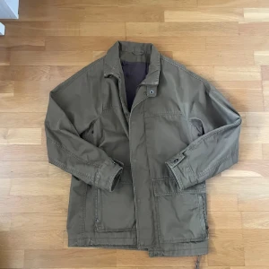 Field jacka - Massimo dutti - Fieldjacka från Massimo dutti. Storlek: L. Skick: 8,5/10, bra skick, har en lite slitning vid armslutet. Innerjacka ingår vilket är perfekt för kallare temperaturer, men går att ta av vid intresse. (Bild 5). Kontakta oss för fler bilder eller info!