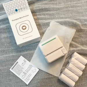  Mini Skrivare - Inkluderar flera rullar termopapper och en enkel användarmanual. Perfekt för att skriva ut kvitton eller små anteckningar direkt från mobilen. 