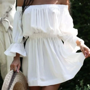 Vit offshoulder klänning - Säljer en söt vit offshoulder klänning nästan identisk med bilden, den har en elastisk midja, perfekt för varma sommardagar, klänningen har även två små knytdetaljer på vardera arm som man kan göra till rosetter för en sötare look💕
