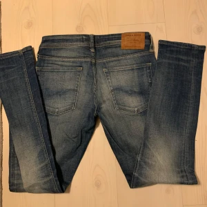 Blå slim fit jeans Glenn - Säljer ett par blå slim fit jeans från Jack & Jones, modell Glenn. Jeansen har klassisk femficksdesign, normal midja och raka ben. Perfekta för dig som gillar en smalare passform och stilren look. W29 L32