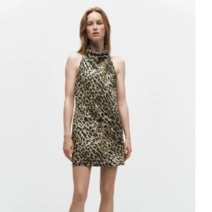 Leopard klänning halterneck HELT NY prislapp kvar - Trendig leopardmönstrad klänning med halterneck. NYPRIS 699! Klänningen är ärmlös och har en kort längd och ser riktigt snygg ut med skärp och höga boots. Perfekt till utekväll eller resturang. PRISLAPP ÄR KVAR