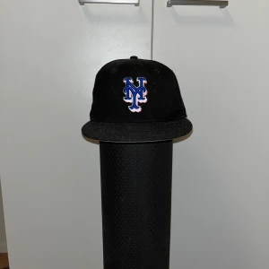 New York Mets Fitted Cap - Fitted Hat thats been used for quite a while now. Size 7. The flashlight makes it look a bit more dirty than it actually is.