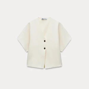 Vit top med knappar från Zara - Snygg vit top från Zara med två knappar framtill, toppen är i bra skick och nästa helt oanvänd!! 