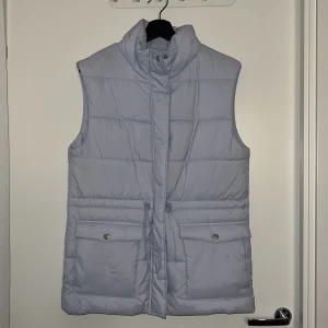 Ljusblå väst från bubbleroom - Ljusblå väst med dragsko i midjan så man kan markera den. Använd ett fåtal gånger. Perfekt för vår och tidig höst.