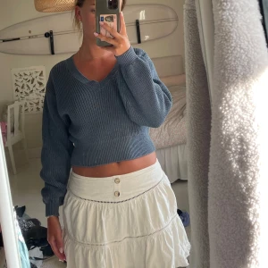 Blå stickad tröja Zara - Säljer en blå croppad stickad tröja från Zara med v-ringning och långa ärmar. Tröjan har ribbad struktur. Som ny.