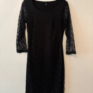 Svart klänning  - Svart klänning som når till knäna.