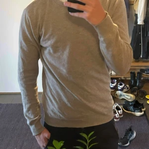 John Henric kashmir - Säljer en beige kashmir tröja från John Henric. Tröjan är gjord av 100% kashmir. Den är i storlek M och passar ganska perfekt för dig som är runt 180-185. Skicket är väldigt bra, säljs då den inte används. 