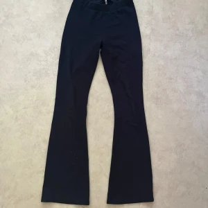 Marinblåa glittriga bootcut byxor från ONLY - Marinblåa, glittriga, bootcut byxor från ONLY i stretchigt bomullsmaterial. Byxorna har hög midja och en klassisk utsvängd passform nertill. Perfekta för en chill dag. Det passar mig då den är väldigt stretchig och jag är 158cm. Kameran gör så de ser lite ”rött” ut på sista bilden😅