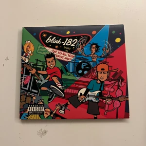 Blink-182 - The Mark, Tom, and Travis Show - Säljer en CD av Blink-182 med titeln 'The Mark, Tom, and Travis Show'. Omslaget har en färgglad tecknad design med bandmedlemmarna i en livlig scen. Inuti finns en booklet med bilder och information om bandet. Perfekt för fans av poppunk och Blink-182! Säljs för 250kr men pris kan diskuteras. Den säljs billigare än andra exemplar dö den ej är testad men bör funka eftersom den förvarats varsamt.