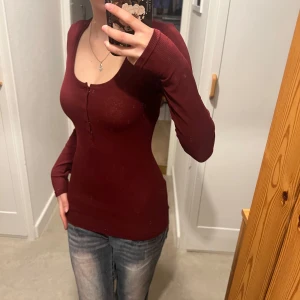 Vinröd långärmad topp - Säljer en vinröd långärmad topp. Den är ribbad och har en tight passform, perfekt för höst och vinter.