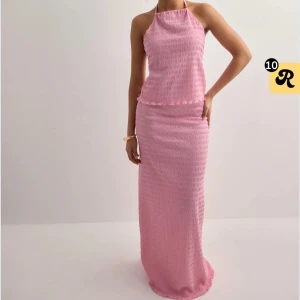 Rosa långkjol - Säljer en söt rosa långkjol med lätt strukturerat tyg. Kjolen har en rak passform, perfekt för alla sommarens tillfällen. Enkel och stilren design som ger en feminin look.🩷🩷🩷helt ny och oanvänd!