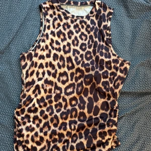 Leopardmönstrad ärmlös topp - Snygg ärmlös topp med leopardmönster. Perfekt för att lägga till lite djurmönstrad stil i garderoben. Passar bra till både jeans och kjol. Aldrig använd. 