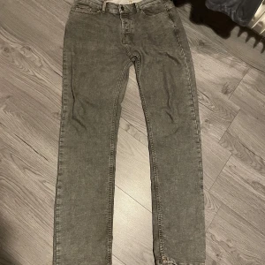 Grå jeans från Montén - Säljer ett par grå jeans från Montén med klassisk femficksdesign och raka ben. De har en normal passform och är tillverkade i ett superflex material så dom sitter bra och är jättesköna. Perfekta för en avslappnad stil.