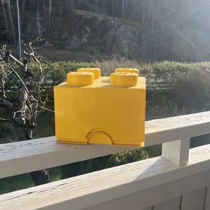 Gul och röd LEGO-förvaringslåda med Lego i - Två stora LEGO-förvaringslådor i plast, en gul och en röd, perfekta för att organisera och förvara LEGO-bitar. Lådorna har klassisk LEGO-design, Säljes med blandade LEGO-bitar i olika färger och former. Du kan välja att köpa en om du vill eller köp båda.