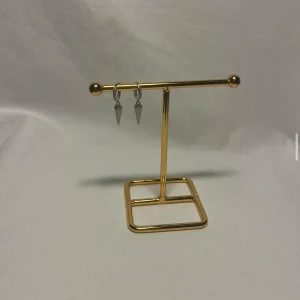 Silvriga örhängen med konformad charm - Snygga silvriga örhängen med små hoops och konformade hängen. Ringen har diskreta detaljer som ger extra glans och en edgy känsla. Perfekta för dig som gillar minimalistisk men cool stil.