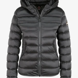 Svart dunjacka från Colmar - Snygg svart dunjacka från Colmar med huva och dragkedja framtill. Jackan är quiltad och har en clean look med diskret logga på ärmen. Perfekt för kalla dagar och riktigt skön att bära. Passar dig som gillar stilren och funktionell design. Vid fler bilder är det bara att skriva 💞står size 14 på jackan. 