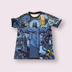 Blå Brasilien Nike fotbollströja - Unik blå fotbollströja från Nike med Brasilien-tema och stort tryck av Kristusstatyn, detaljerade illustrationer och gula loggor. Tröjan har svarta muddar och är tillverkad i lätt, ventilerande material. Perfekt för dig som vill sticka ut på planen.