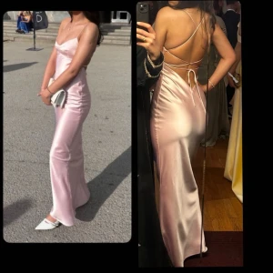 Ljusrosa långklänning i satin med öppen rygg - Rosa balklänning från babyboo! Ny, använt den endast en gång på min bal. Extremt bra material den ser inte billig ut, dubbel lager. Jag är 167cm vanligtvis, med skorna jag hade på mig blev jag runt 169-170cm. Justerbara band både vid midja och bröst, även en kedja vid sidan så den sitter åt fint.