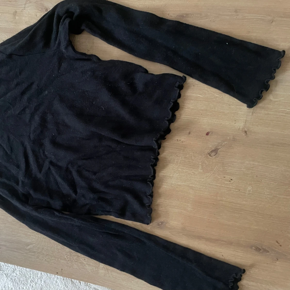 Svart finstickad polotröja med volangkant - 1