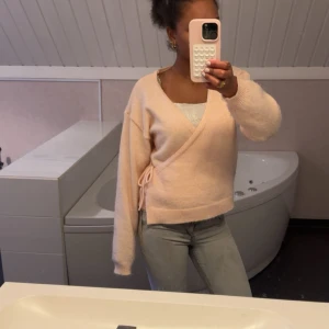 Ljusrosa omlottkofta från Lindex - Slutsåld och oanvänd ljusrosa omlottkofta från Lindex i storlek S. Den köptes i vintras på Lindex för 400kr och har aldrig använts. Koftan har knyt i sidan med en rosett. Perfekt för sommarkvällar. 