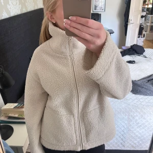 Beige teddyjacka med dragkedja - Säljer den här supermysiga och populära teddyjavkan från HM!❣️Jackan är använd men har inga jättetydliga defekter! Bara att skriva vid frågor