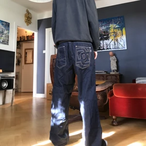 Baggy DNGRS byxor - Baggy indigo färgade DNGRS byxor, snygga custom knappar och märket broderat vid fickan, storlek 34/34 