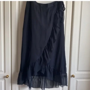 Lång volangkjol - Svart lång omlott volangkjol från Vero Moda. Strl S