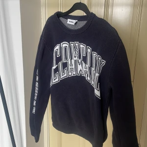 Marinblå tröja med tryck - Marinblå tröja från Weekday! Har flera "tryck", fram på vänster arm, bak på höger arm och på framsidan. Köpt för ca 2 år sedan och är väl använd! Storlek S, men är stor i storleken. 