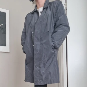 Lång trenchcoat  - Grå/silvrig trenchcoat. Lite skrynklig men i bra skick!