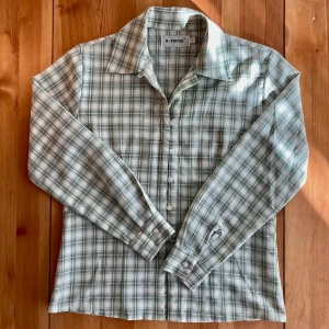 Klassisk snygg skjorta - Jättefin rutig skjorta från märket B-Young. Krämvit och ljusgrön i färgen. Gjord i främst polyester. Saknar den näst översta knappen, men annars i bra skick, använd fåtal gånger. Möts antingen i Uppsala eller postar💕
