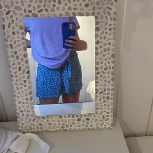 Blå skjorta från hm🦋💙 - Blåa skjorta med vita blommor som rö nästan oanvänd och kmr från hm. Stretchiga i midjan med en rosett runt midjan💙 