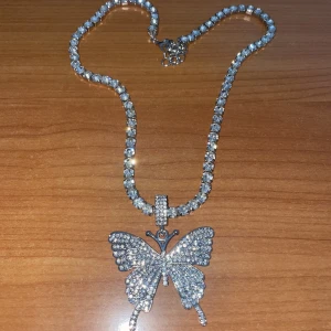 Silverfärgat halsband med stenar och fjäril - Helt ny, inte använd. Bra kvalitet och fina stenar. 