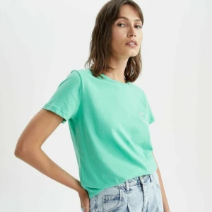 Thsirt  - Säljer denna tshirt från Zalando märket De facto för 50 kr (ursprungspris 152 kr).   Prislappen kvar.   100% bomull.   Enligt zalando bilden framgår det att färgen är turkos, stämmer ej.   Går inte att köpa mer (gammal screenshot).  Tryck:keep on smiling