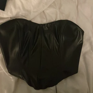 Skinn korsett - Fin till fest eller nått sånt. Vet inte stolen men passar mig som är S. Den är ganska töjbar. 