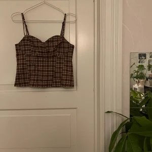 Korsett topp🤍 - Korsett topp, rutig, brun. Med byglar. Från H&M, storlek 42. Ny med lappar. Kan mötas i Göteborg eller skicka, köparen står för frakt.