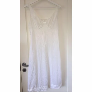 Vit klänning - Vit klänning med spetsdetaljer! Den har en lapp på sig där det står att den är från något klädmärke som heter ”Wafers Sweden Eve”. Den är i storlek s och i bra skick! Passformen är pösig 