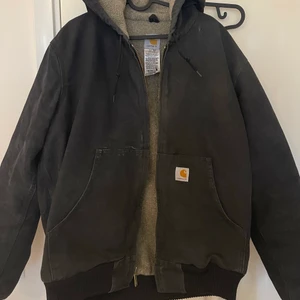 Carhartt jacka - En höst/vinterjacka från Carhartt i jättefint skick!! Den är i en urtvättad svart färg och har en bomberjacka modell. I storlek L från herravdelningen men passar alla beroende på hur man vill att den ska sitta! 