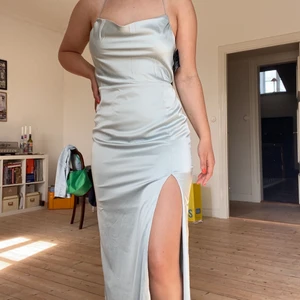 Balklänning - Säljer en balklänning från NLY eve då jag ej har användning för den! Köpt från Nelly i år. Öppen rygg med hög slits på vänster sida. Jag är 168cm och den är perfekt längd med klackar! Aldrig använd, prislappar sitter kvar! Köparen står för frakt 💕🥂✨