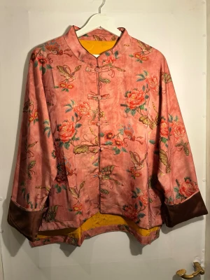 Silkesjacka i konstnärlig stil – Kesi-teknik (traditionellt hantverk) - 📐 Storlek & passform 	•	One size 	•	Avslappnad / rymlig passform 	•	Byst: ca 134 cm 	•	Längd fram: ca 57 cm 	•	Längd bak: ca 64 cm  🧵 Material 	•	95 % siden 	•	5 % elastan