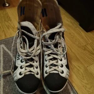 Svarta och vita skridskor från Jofa Strl 38 - Klassiska svarta och vita skridskor från Jofa, modell Jet. Skorna har snörning, robust plastsula och tå, samt detaljer i syntet och skinn. Perfekta för dig som vill glida fram på isen med stil. Snygg kontrast mellan svart och vitt med märkets logga på sidan.