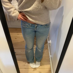 Low waist bootcut jeans - Säljer ett par bootcut low waist jeans i ljusblå. Jeansen har klassisk femficksdesign och är tillverkade i mjukt denimtyg. Perfekta för dig som gillar en avslappnad och trendig look. Storlek 164 och jag är 165 och bär oftast S. De är använda men ingen anmärkning.