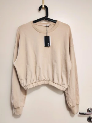 Beige croppas tröja i strl.M (Oanvänd) - ✨ Jag rensar allt jag inte använder längre eller har använts som bara hänger i garderoben. Nypris 157