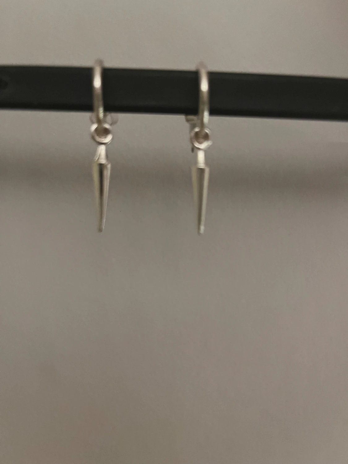 Silvriga örhängen med spetsig hängande detalj