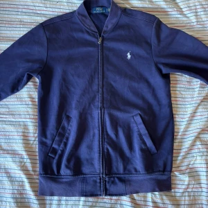 Ralph lauren zip - 🔵🔵Säljer Ralph lauren zip up i marinblå🔵🔵 säljer denna för att jag inte har någon användning för den. Skick 8/10 på grund utav att den har blivit tvättad några gånger men annars så är det inget fel.